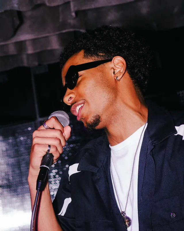 Singer holding a microphone during a live performance